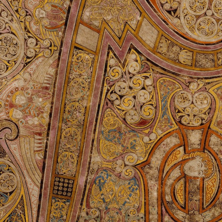 A close up of intricate illustrations featuring snakes in the Book of Kells