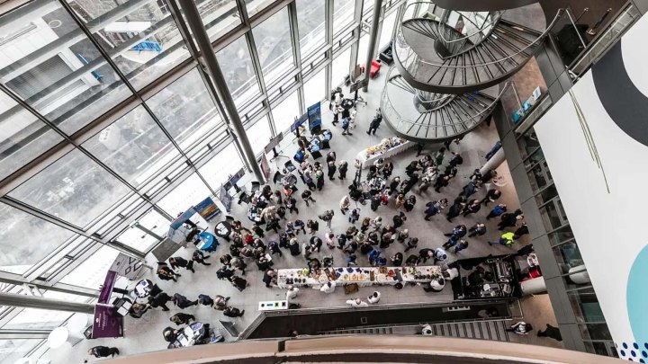 downwards view of businesspeople in a lobby at an event