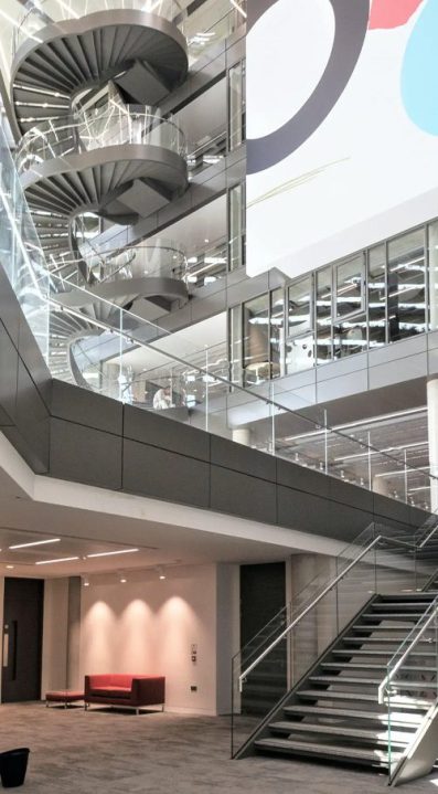 view of stairs leading to a spiral staircase