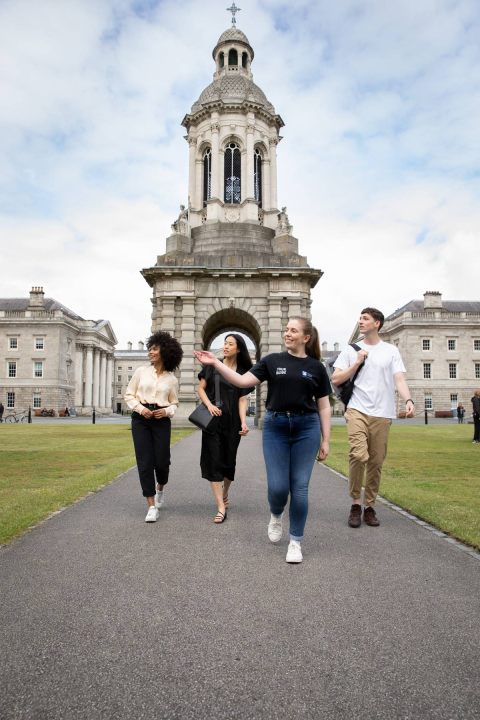 tour guide and tourists in front of trinity campus