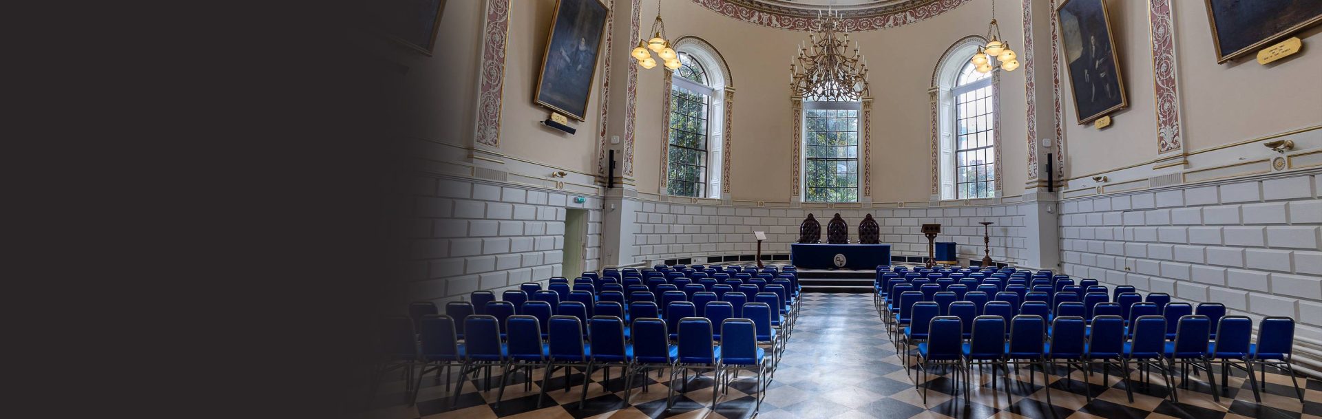 view of trinity college examination hall with blue seats facing forward