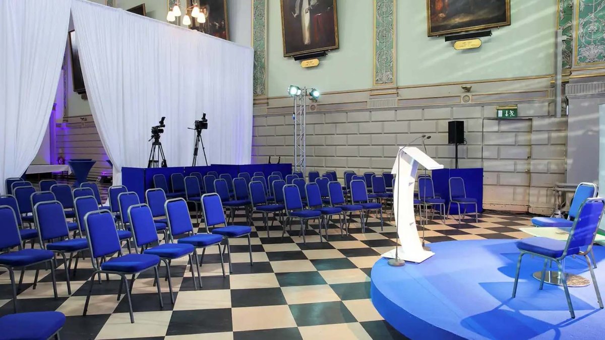 raised platform with chairs arranged in trinity college exam hall