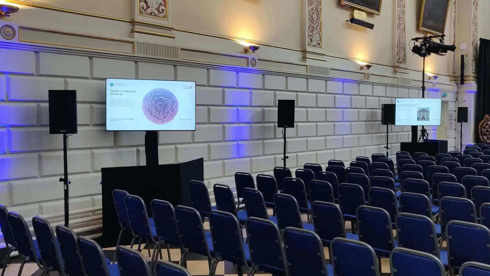 screens facing rows of chairs at trinity