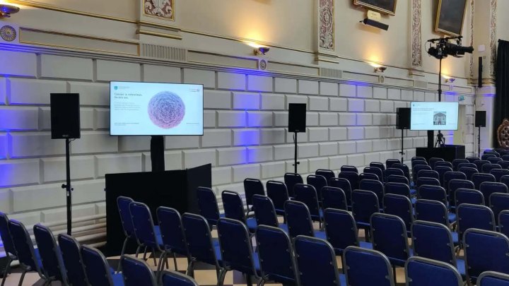 screens facing rows of chairs at trinity