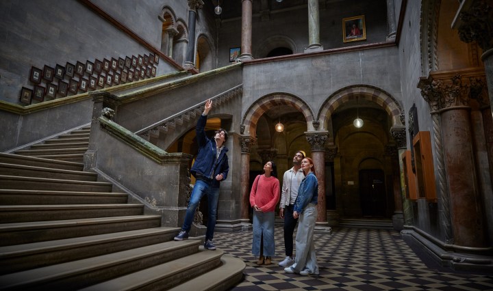 Tour Guide with visitors in museum building