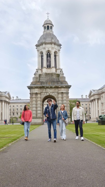 Tour guide walking through Trinity's Front Square with a group of 3 people.