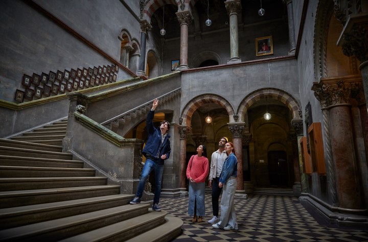 A tour guide with a group in the Museum Building in Trinity