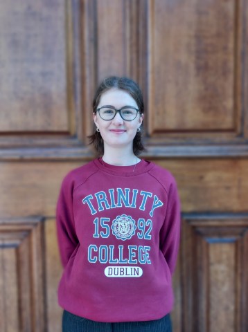 Tour guide on front of a door in Trinity College Dublin