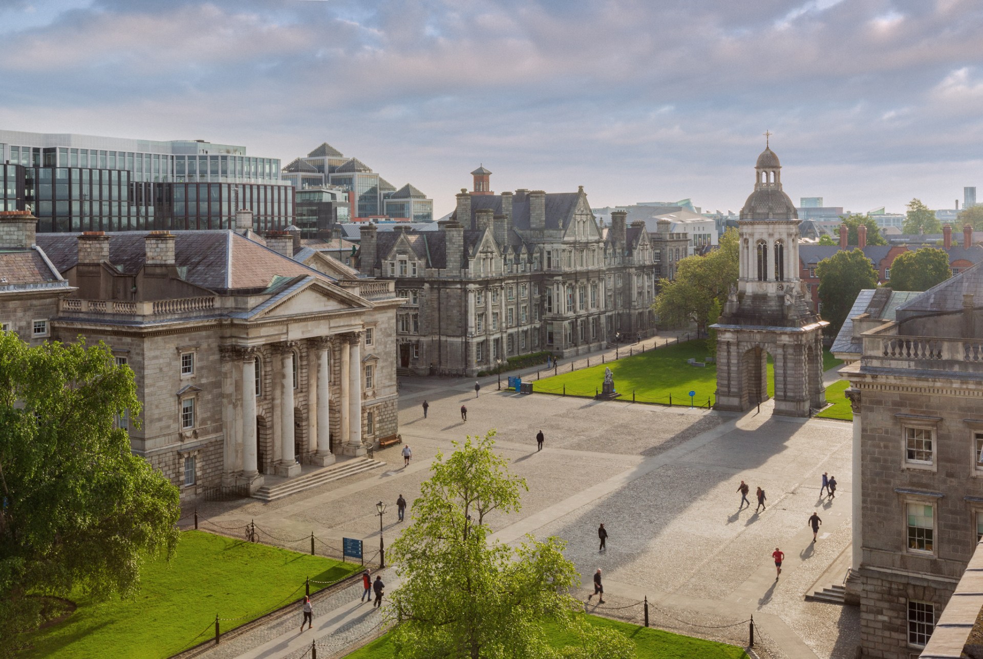 Bird's eye view of Trinity Square with sun shining and people walking