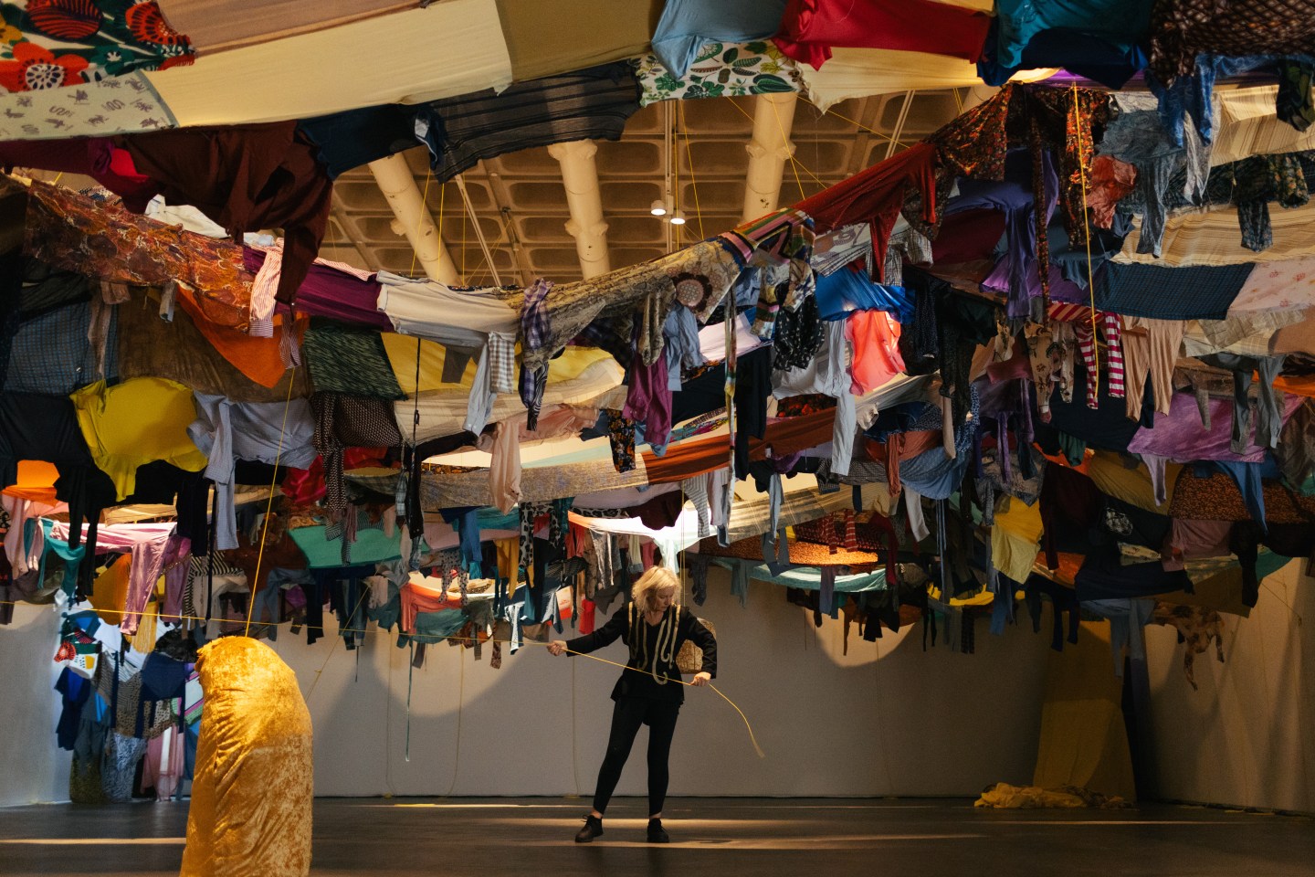 Amanda Coogan, performance artist surrounded by colourful material in the Douglas Hyde Gallery