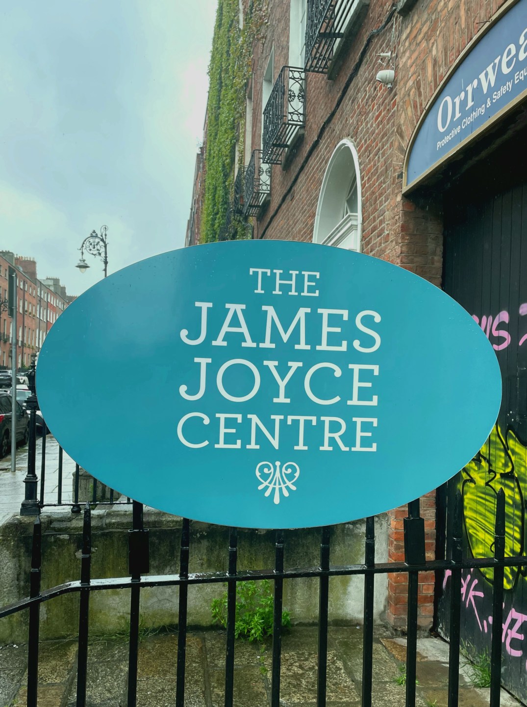 A blue sign saying James Joyce Centre outside a red brick Georgian building