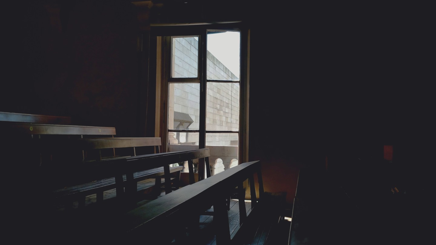 Brown wooden benches in an old classroom