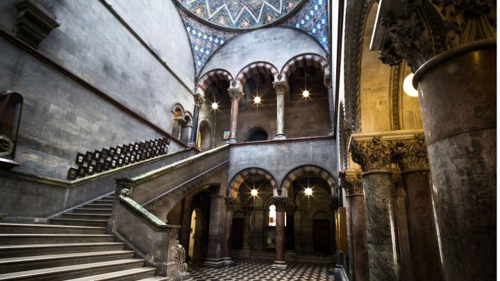 A green marble staircase and dome roof in the entrance hall of the Museum Building